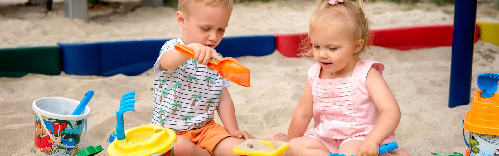 Learner playing with toys in the sandbox.