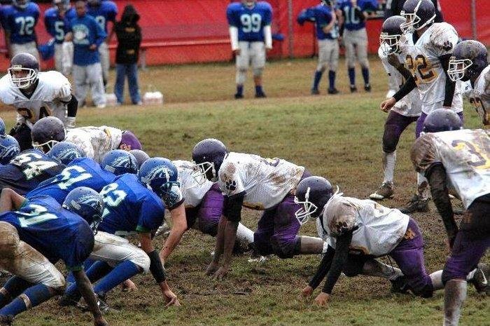 football players down for the snap on the football field