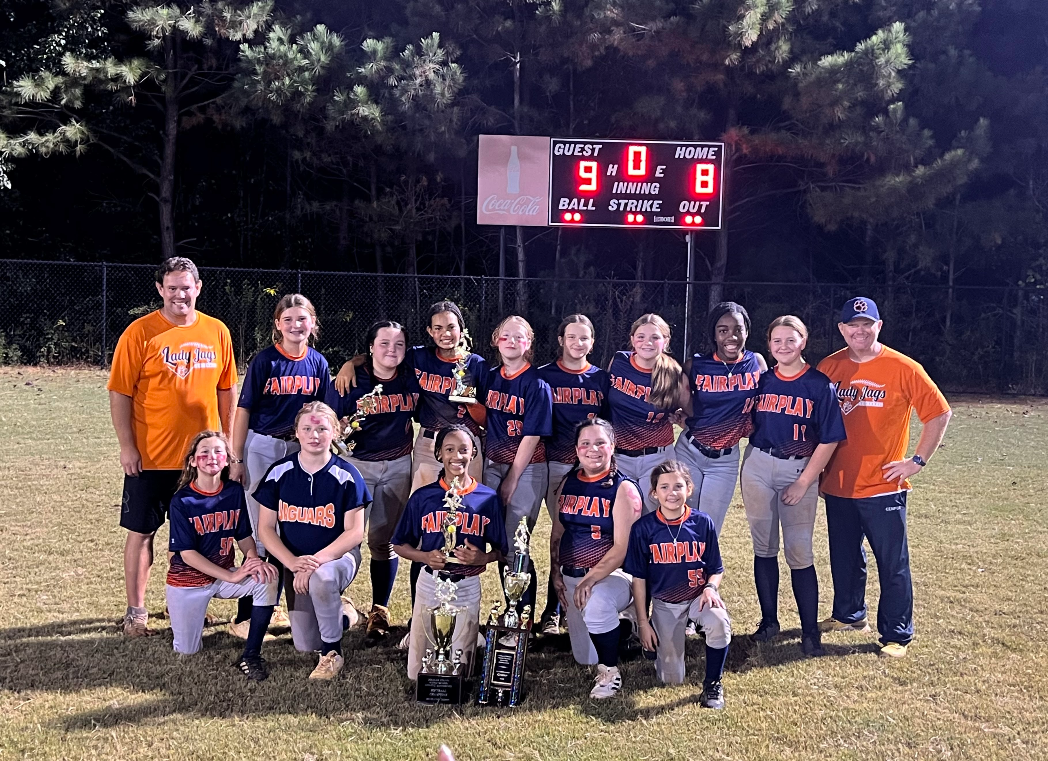 Picture of the Softball team with a trophy