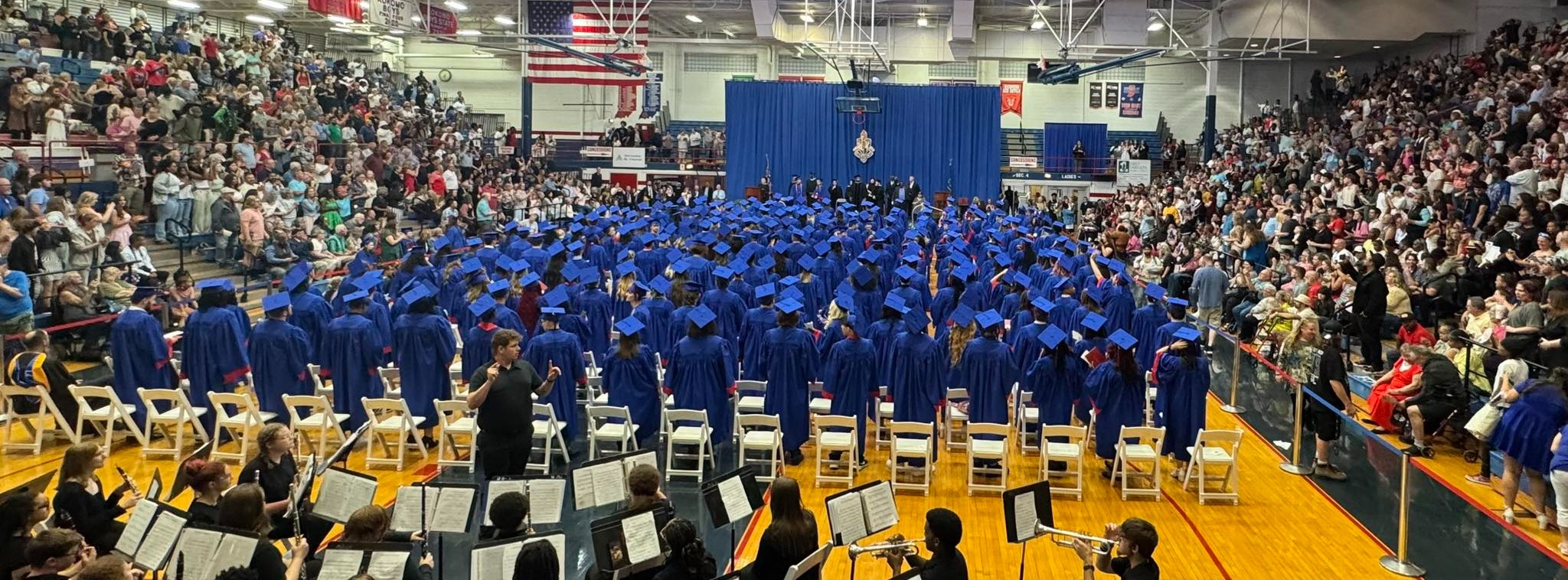 Graduation students in blue caps and gowns