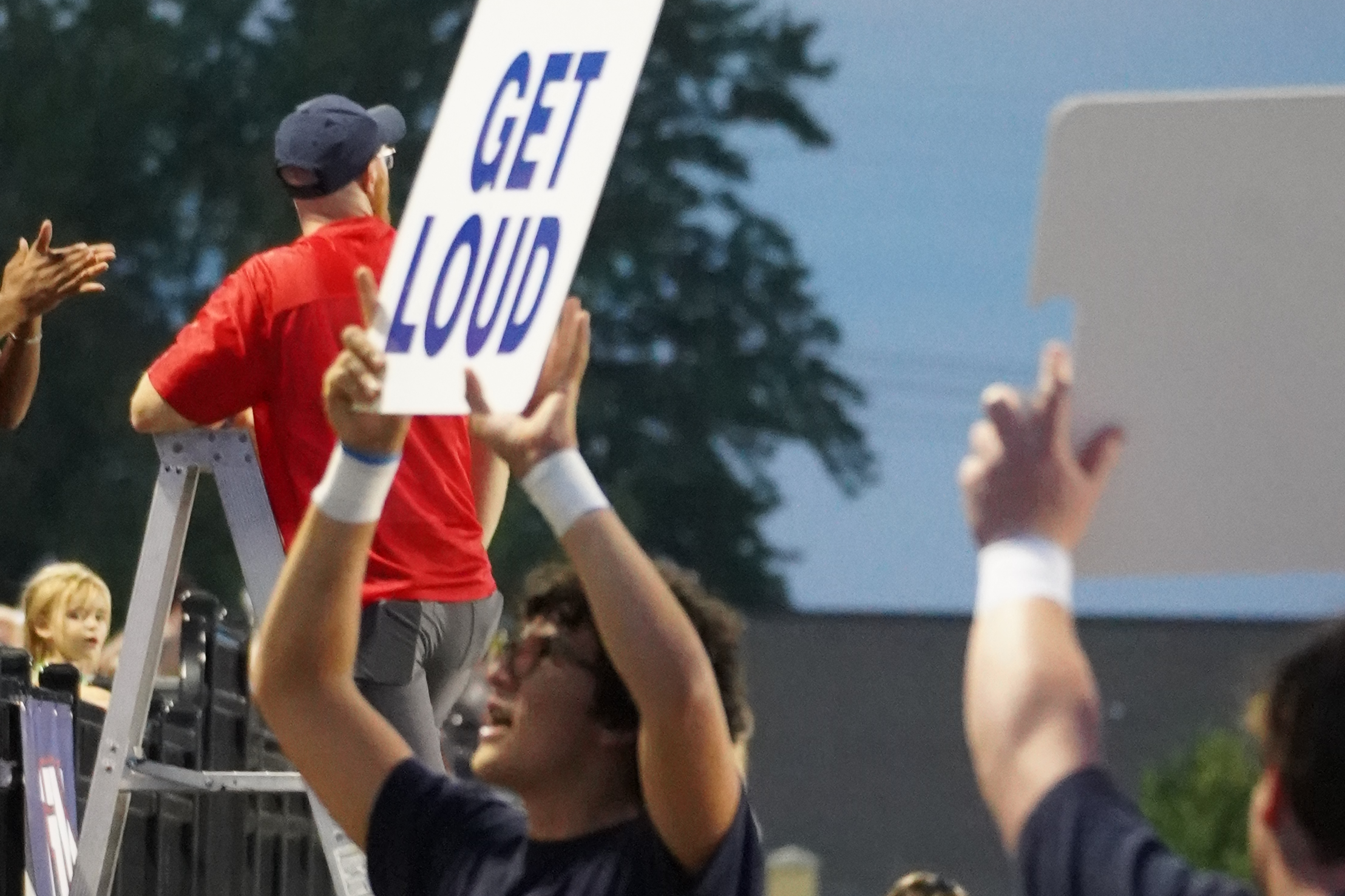 student with get loud sign
