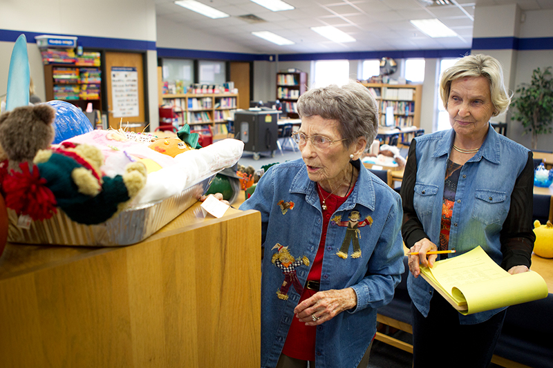 Mrs. Bennett (left) helps judge a literary pumpkin decorating project at Bennett Elementary.