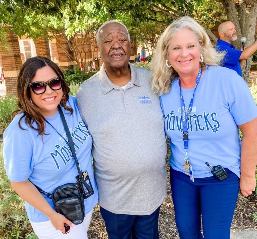 Jesse McGowen takes photo with school principal and assistant principal