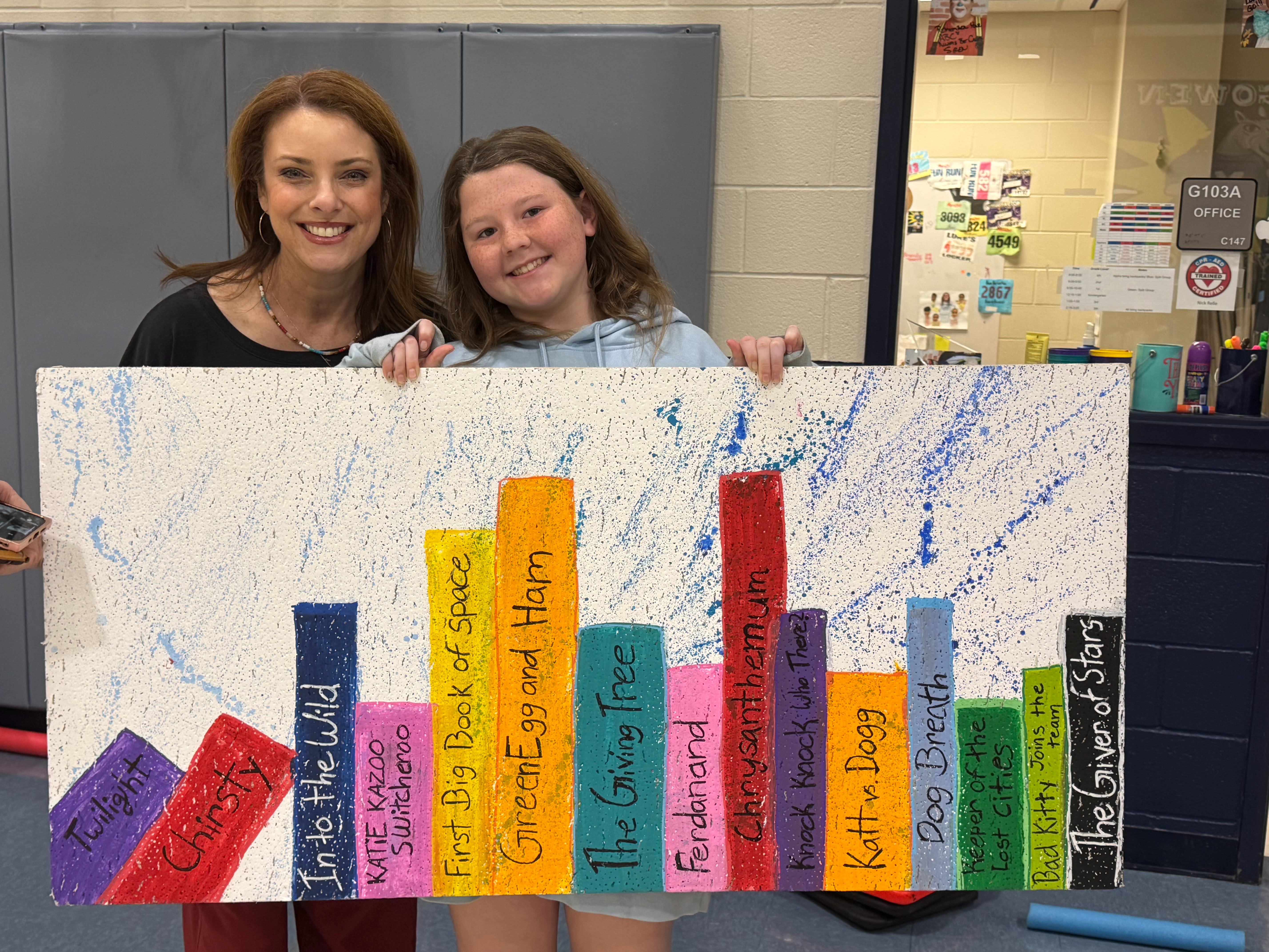 Student gifts the librarian with a personalized slide.r