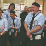 teacher stands with group of student all wearing ties