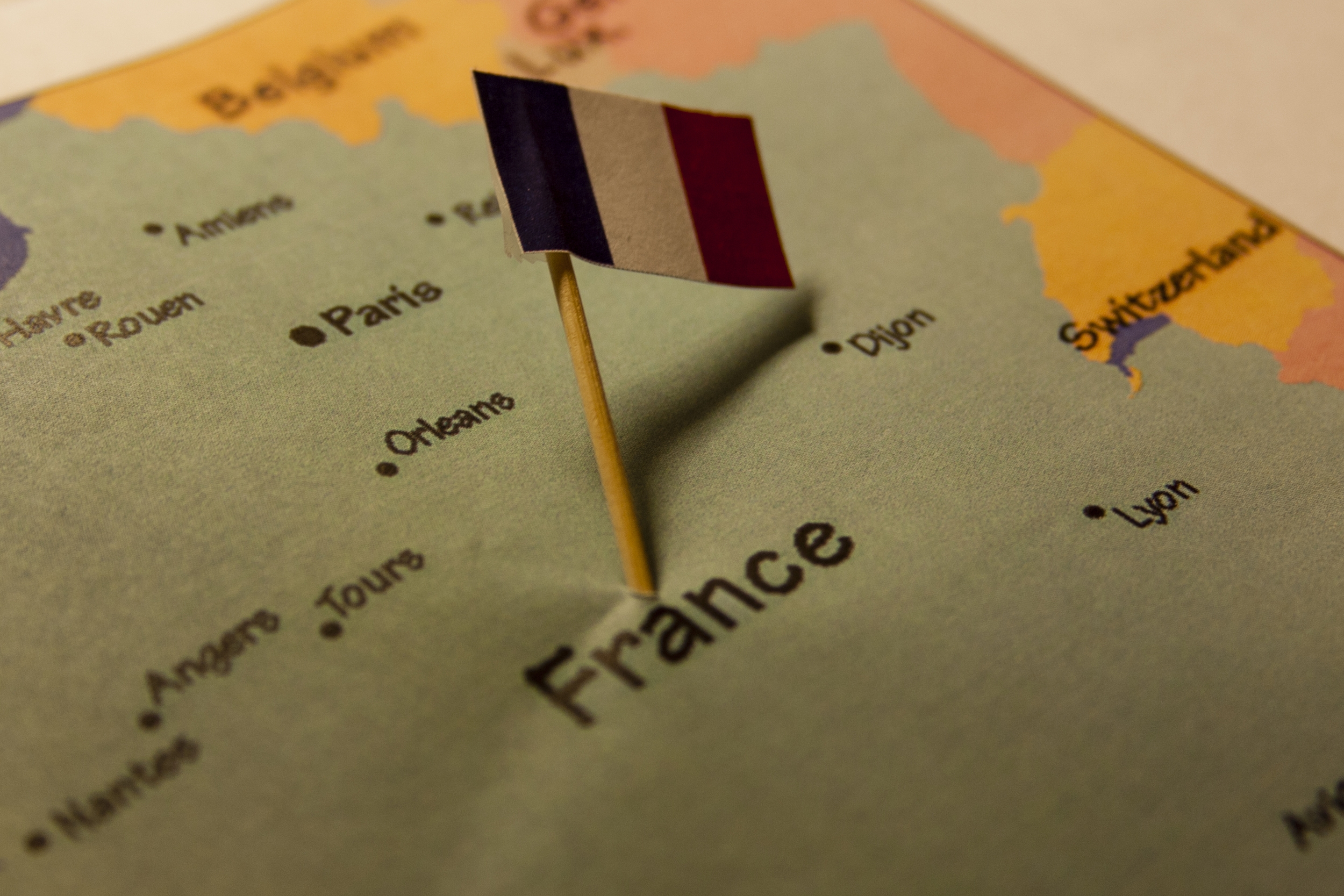 France map with flag: A map of France with its national flag displayed. The flag consists of three vertical stripes of blue, white, and red.