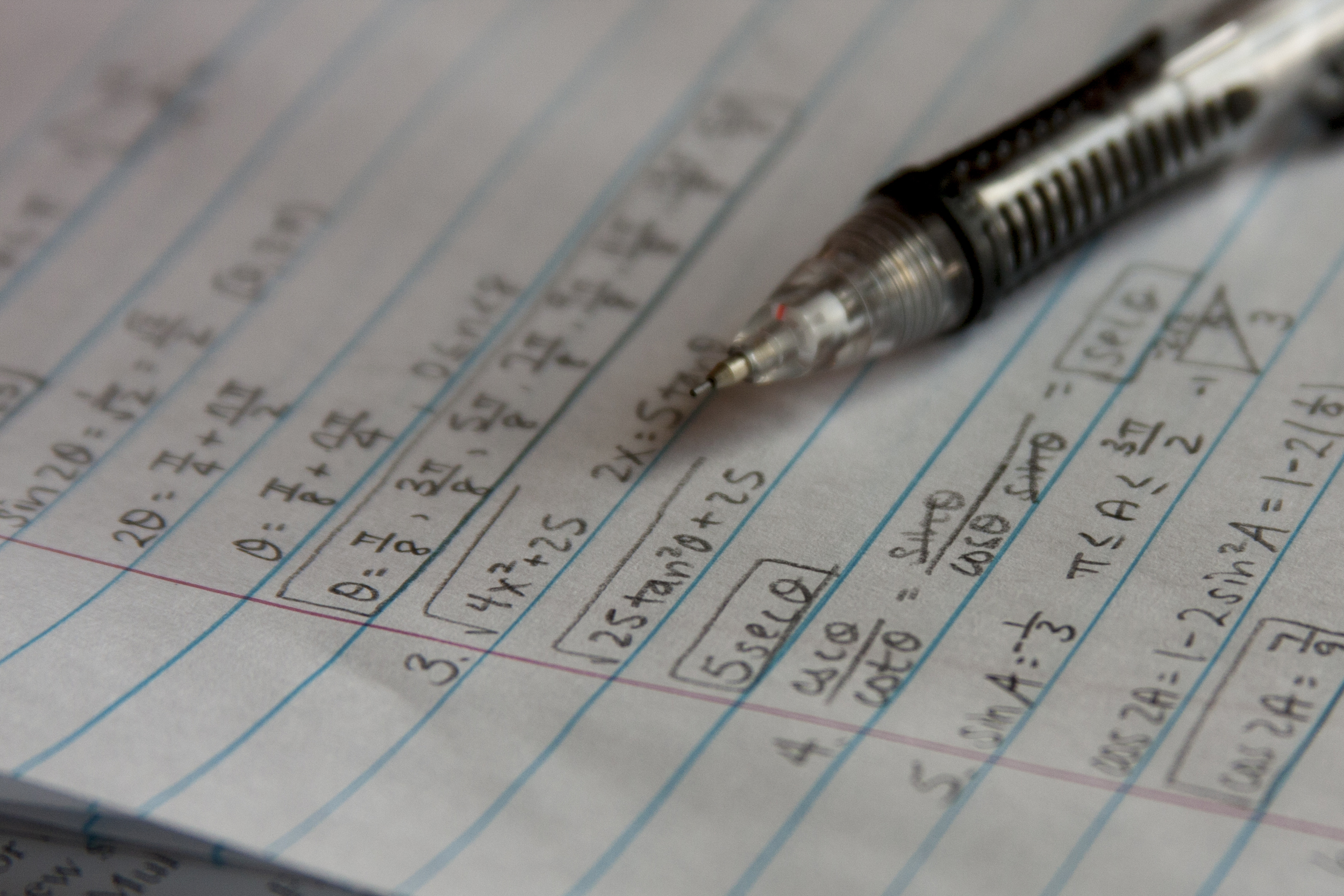 A pen lying on a paper surface.