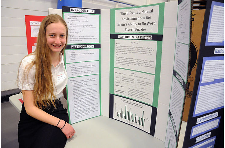 Student showing their research results