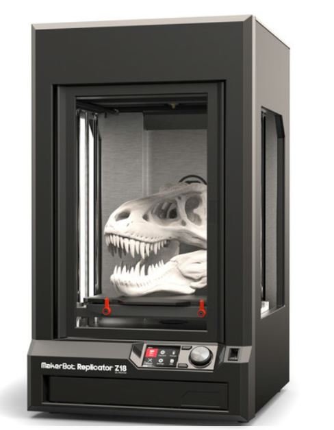 A 3D printer with a skull decoration on top.