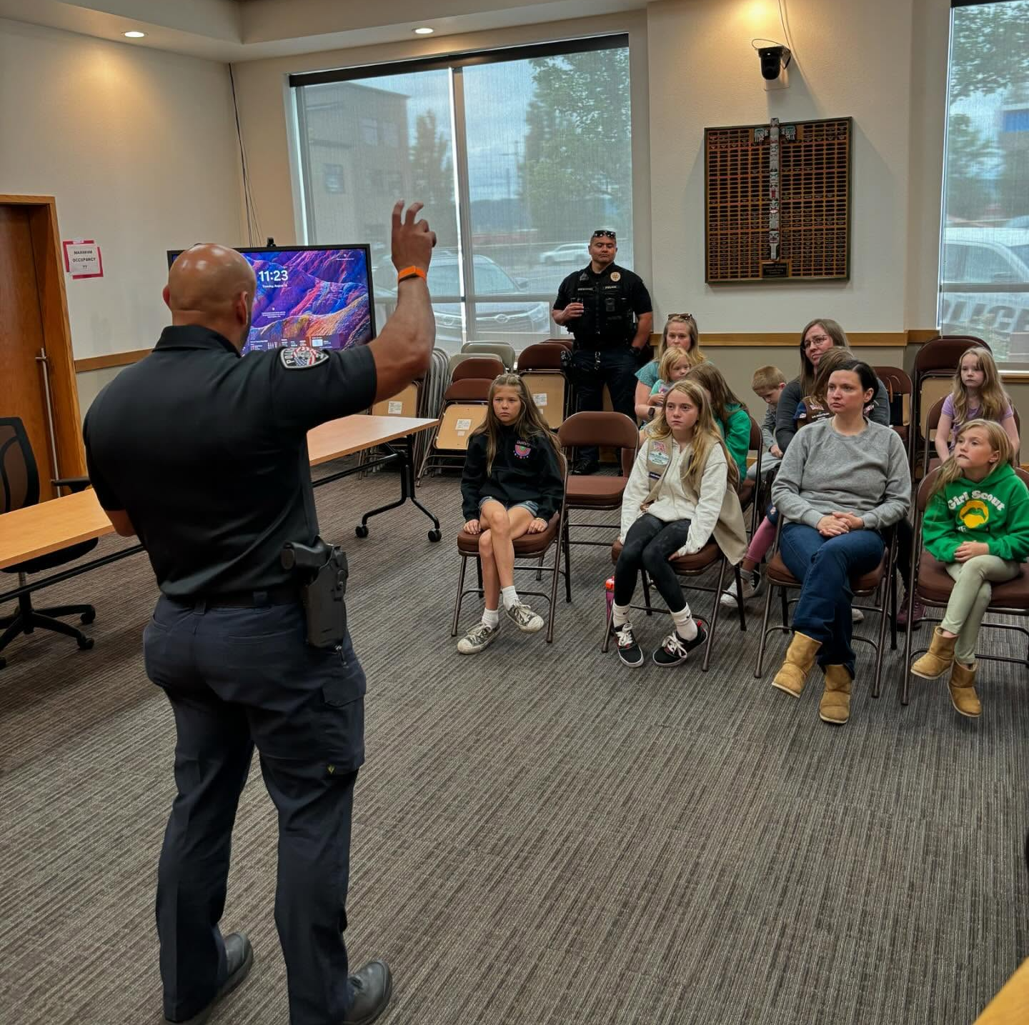 police chief making a presentation to the local girl scouts about government
