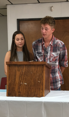 students on a stand speaking out