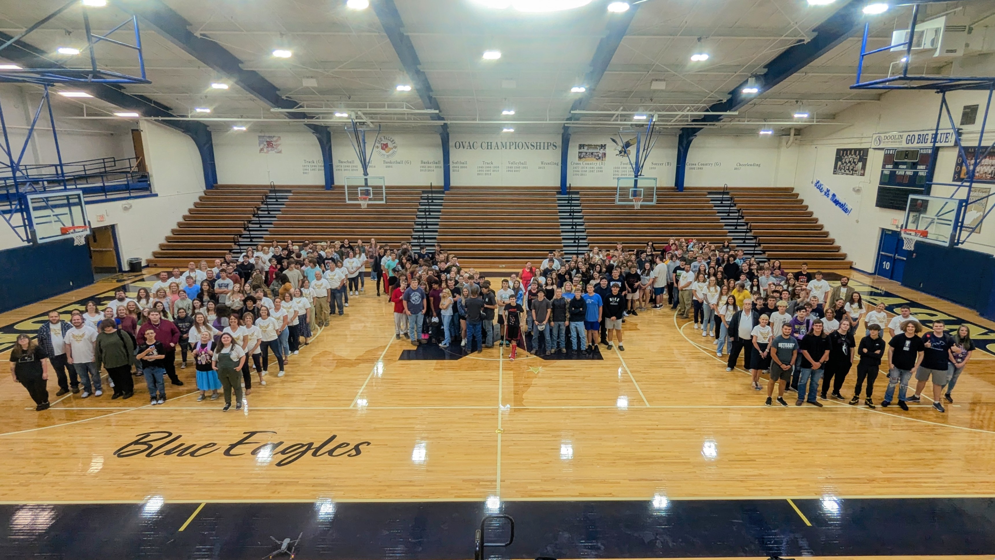 MHS students on the first day, standing in the gym in a "M" form .
