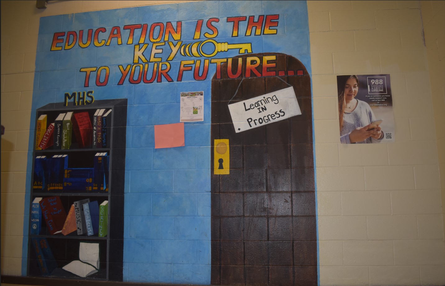 Wall Mural @ MHS of a bookcase and door with the saying" educaation is the key to your future". 