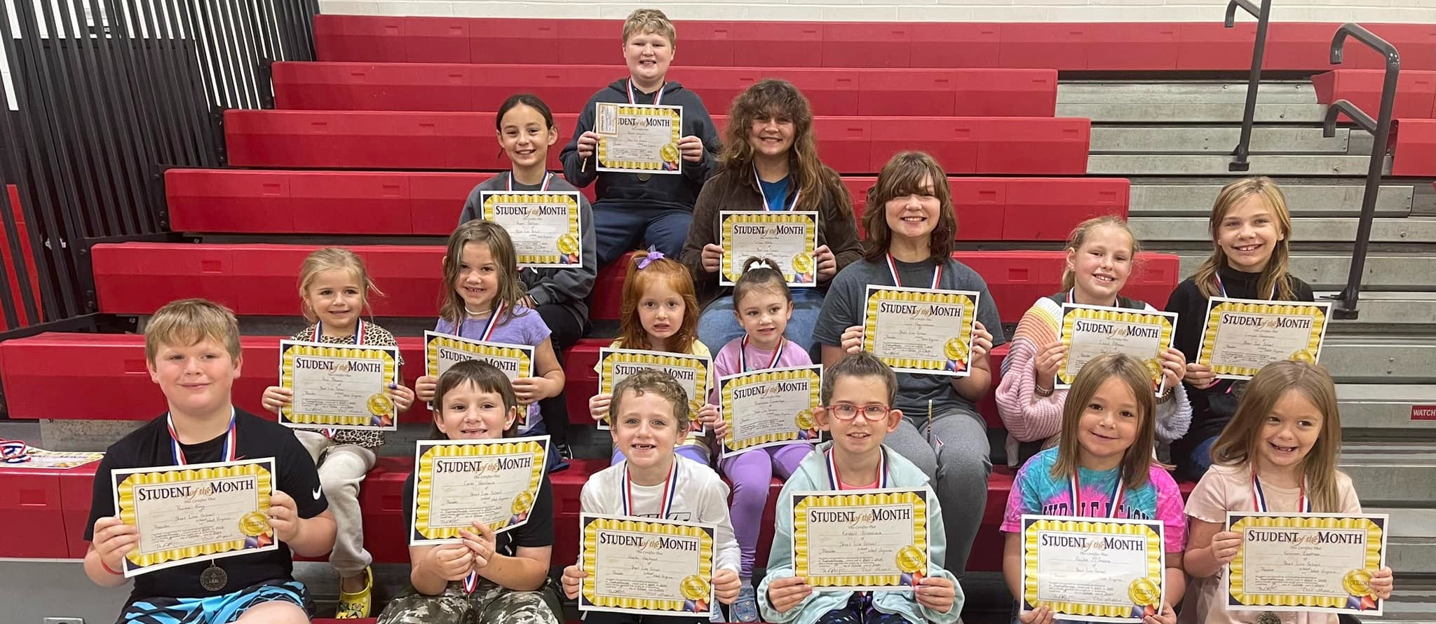 Students posing with their student of the month certificates. 