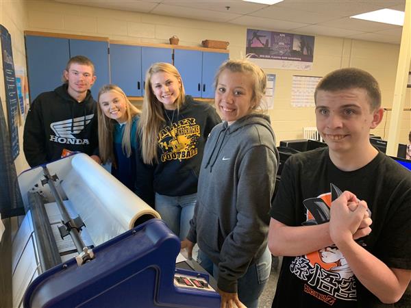 Students working together on a printing press