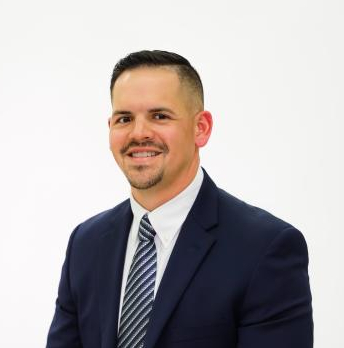 A photo of a man in a suit and tie