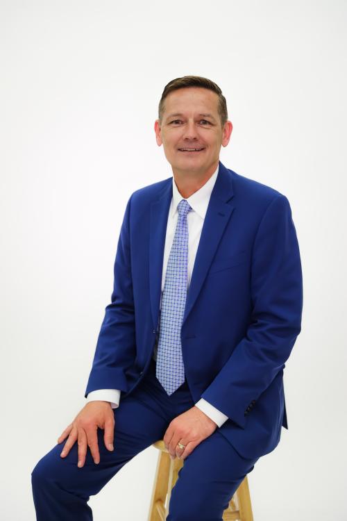 A photo of a man in a suit and tie