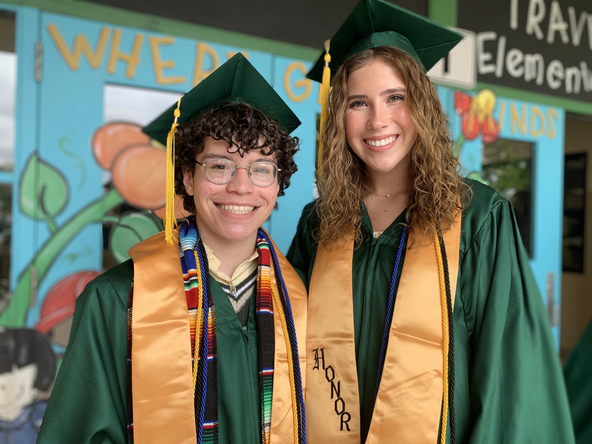 Two seniors in their cap and gown