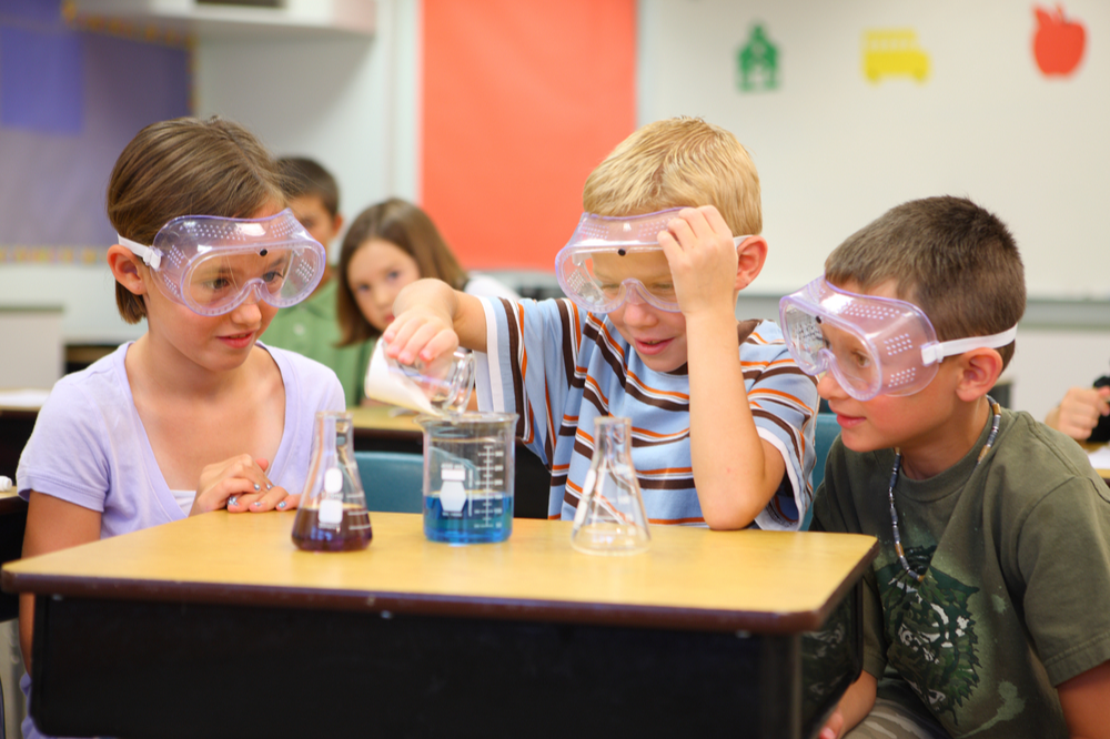 elementary students doing an experiment 