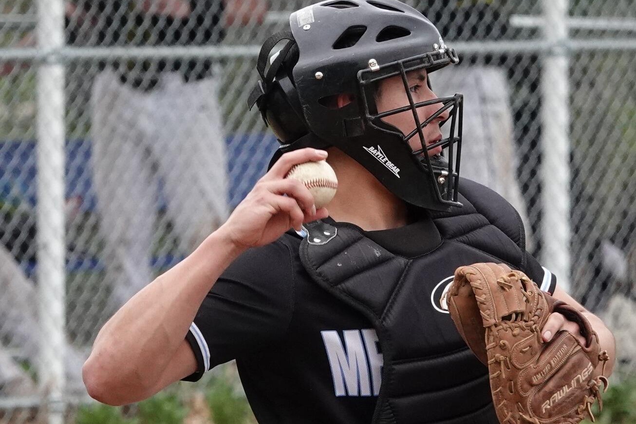 Student Athlete preparing to throw baseball while kneeling