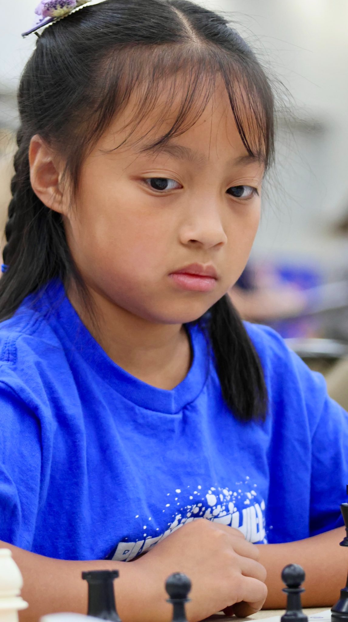 Student studying chess board