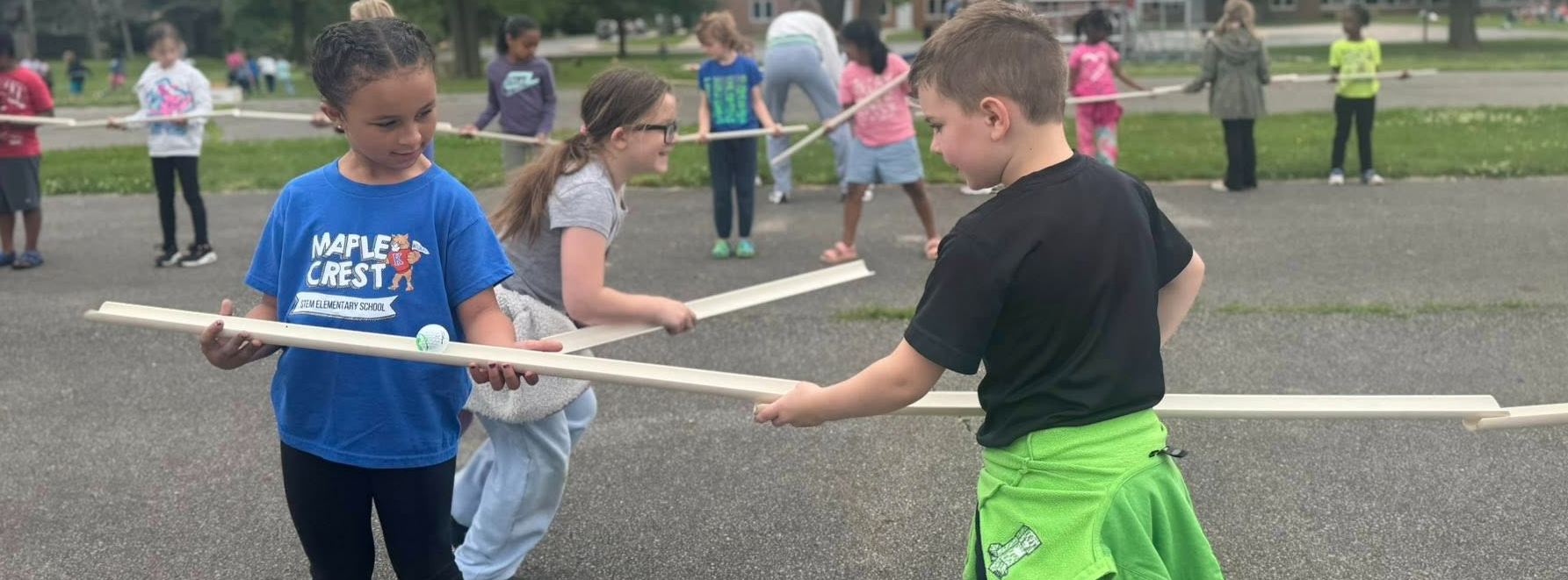 Young elementary age students exploring classroom activities