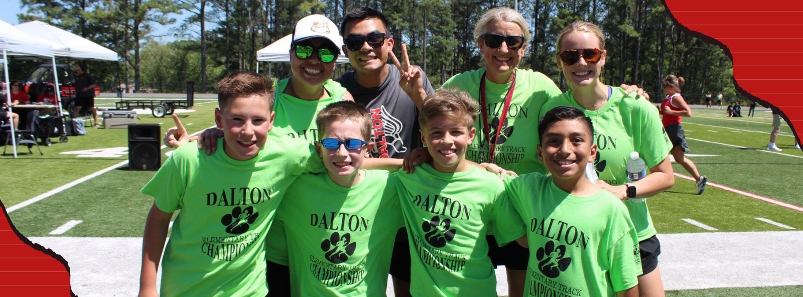 A group of students on the track meet with Westwood Track coaches and a DHS students at the DPS Elementary Track Meet