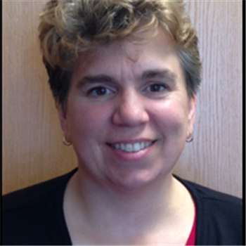 A woman with a short hair wearing black shirt.