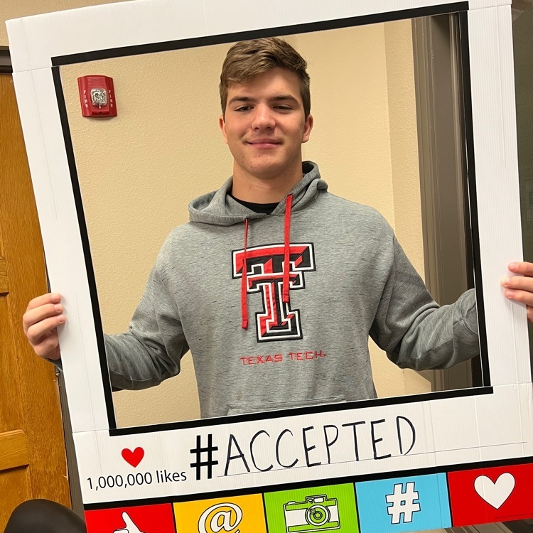 student wearing texas tech hoodie and  holding frame that showcases his college