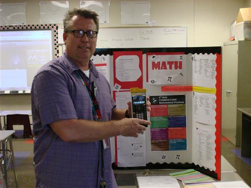 Teacher pointing to a board 