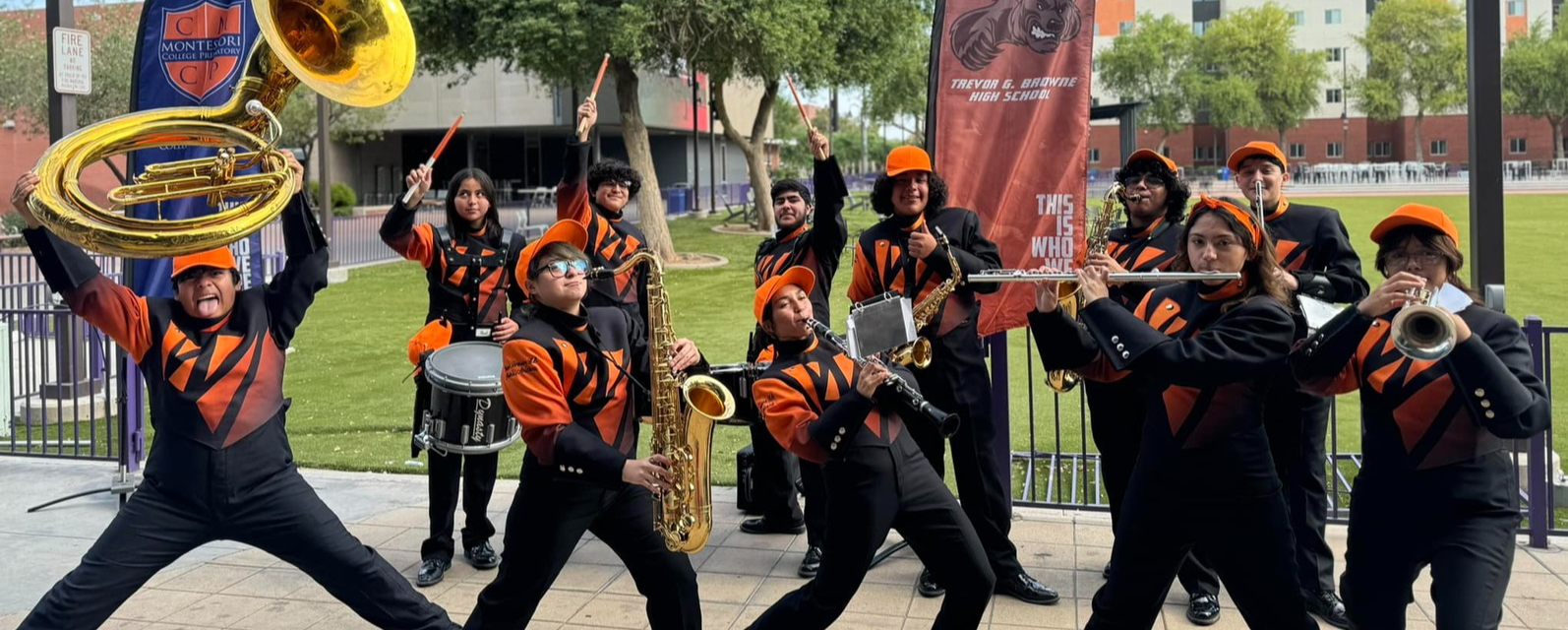 Band students outside the school building with instruments