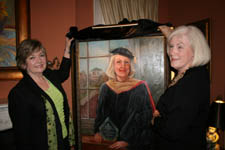 ladies holding portrait frame/painting