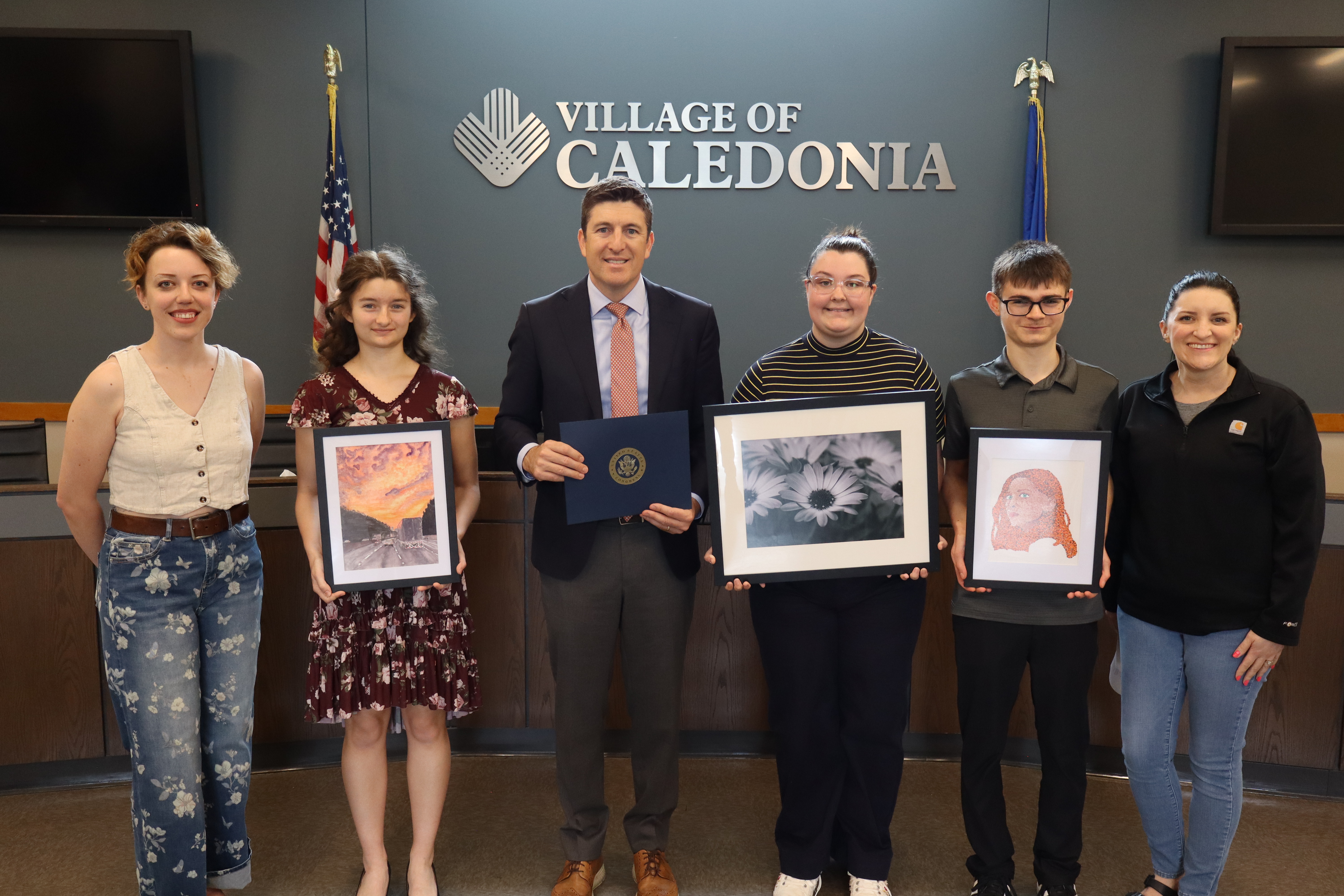 Students standing with their art
