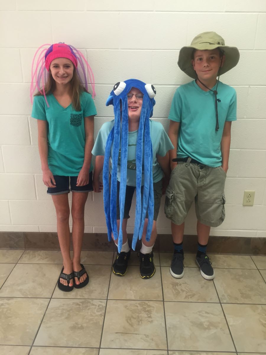 A group of kids standing next to each other