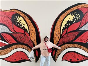 Group member in butterfly mural