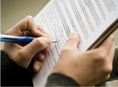person writing on a document