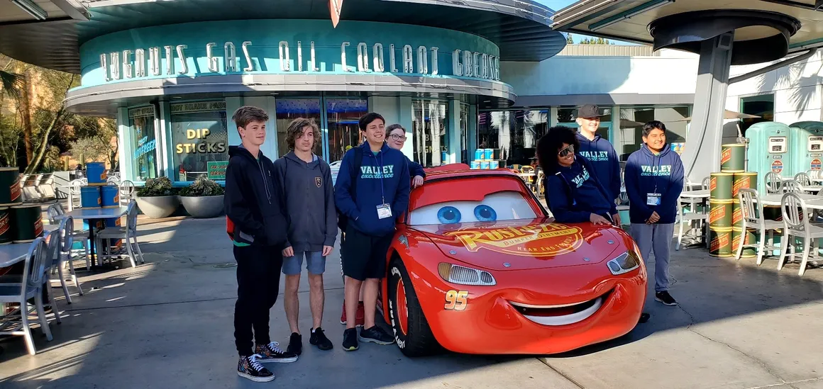 students posing with Lightning McQueen from movie Cars