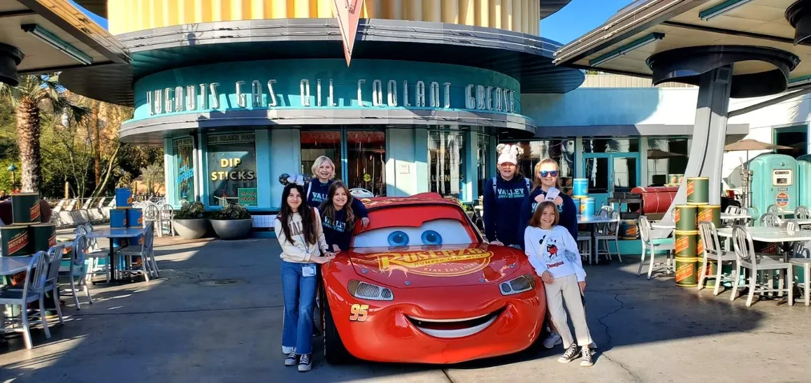 students posing with Lightning McQueen from movie Cars