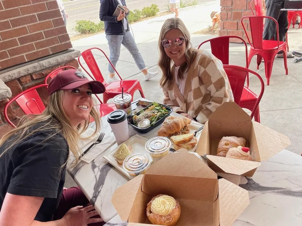 two women at table eating lunch