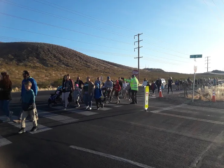 students walking on the street a mountain in the background