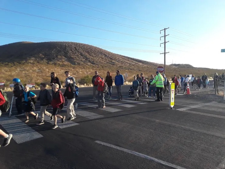 students walking on the street a mountain in the background