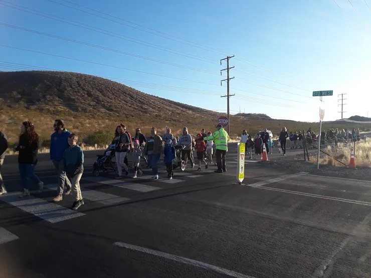 students walking on the street a mountain in the background