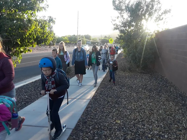 students walking on the street a mountain in the background