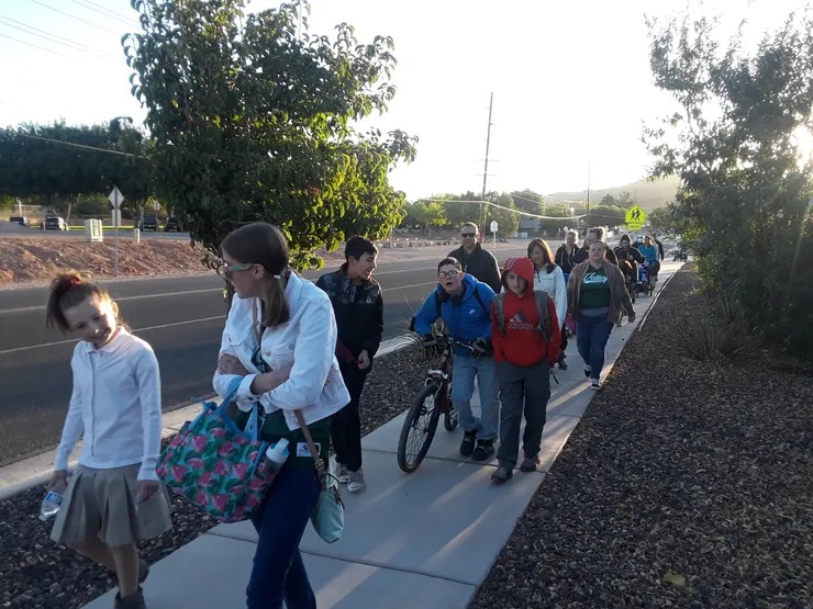 students walking to school by the side walk