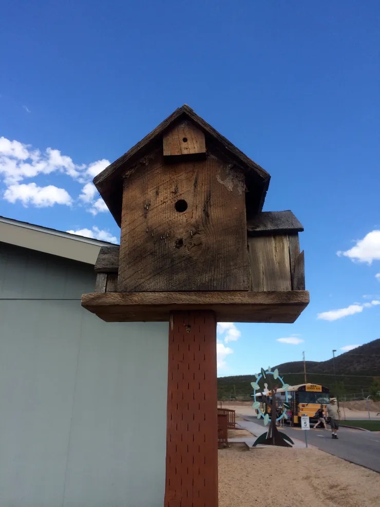 This is an image of a wooden birdhouse.