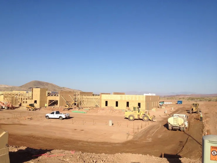 Under clear skies, a construction site in progress showcases multiple structures 