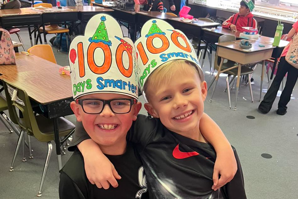 two boys with 100 days smarter hats