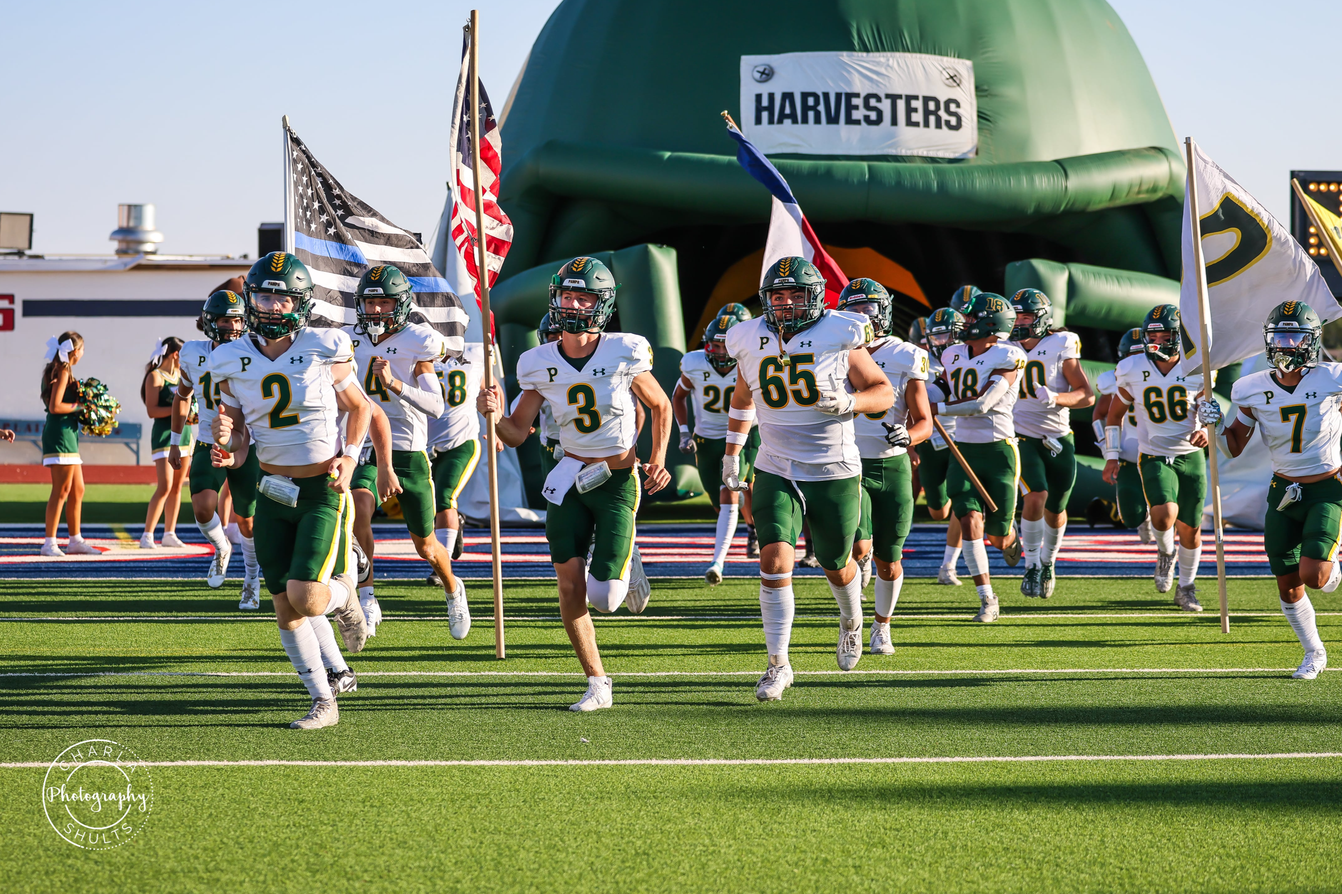 football players running out of helmet with American flag