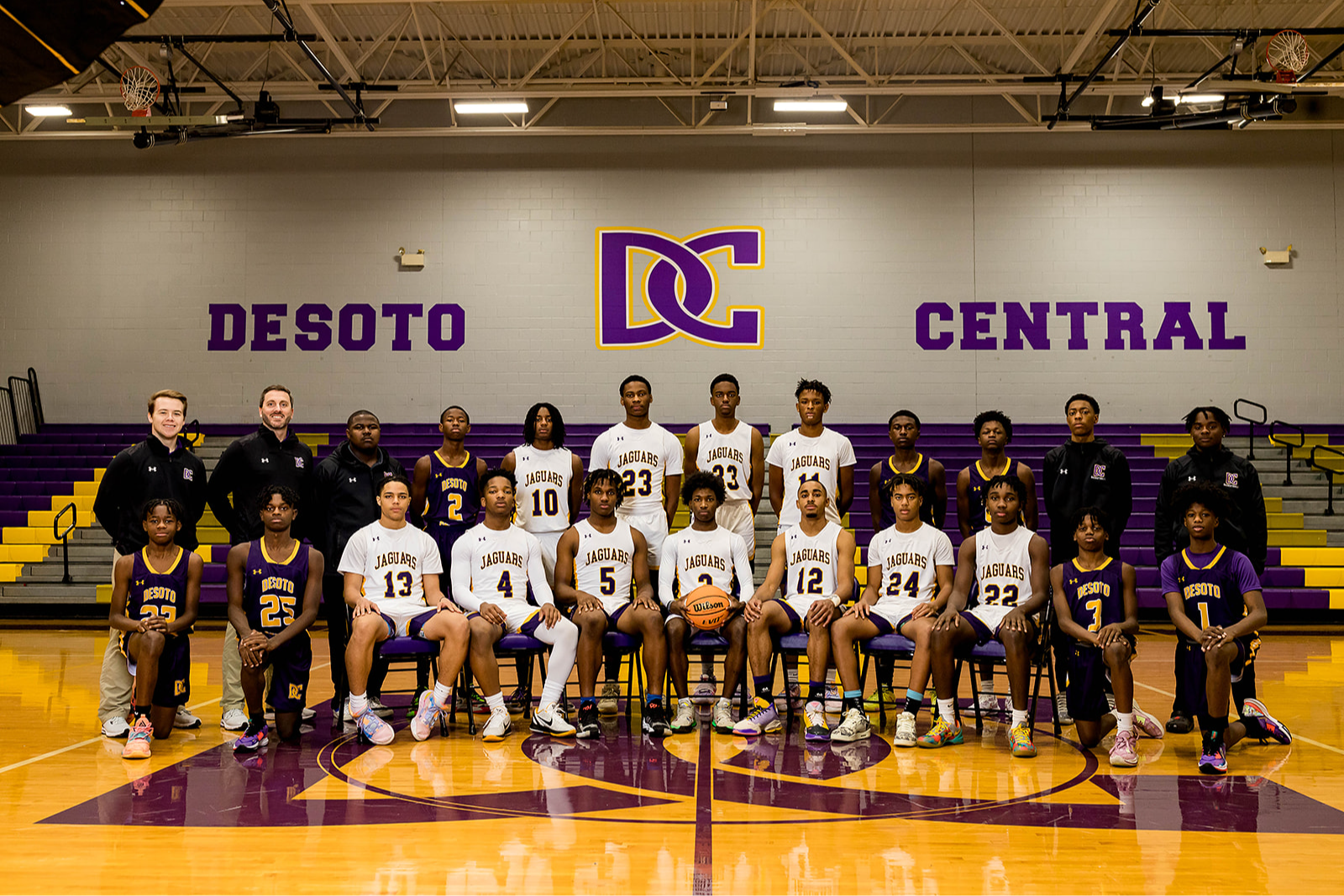 Desoto Central basketball team posed in uniforms in the school gym