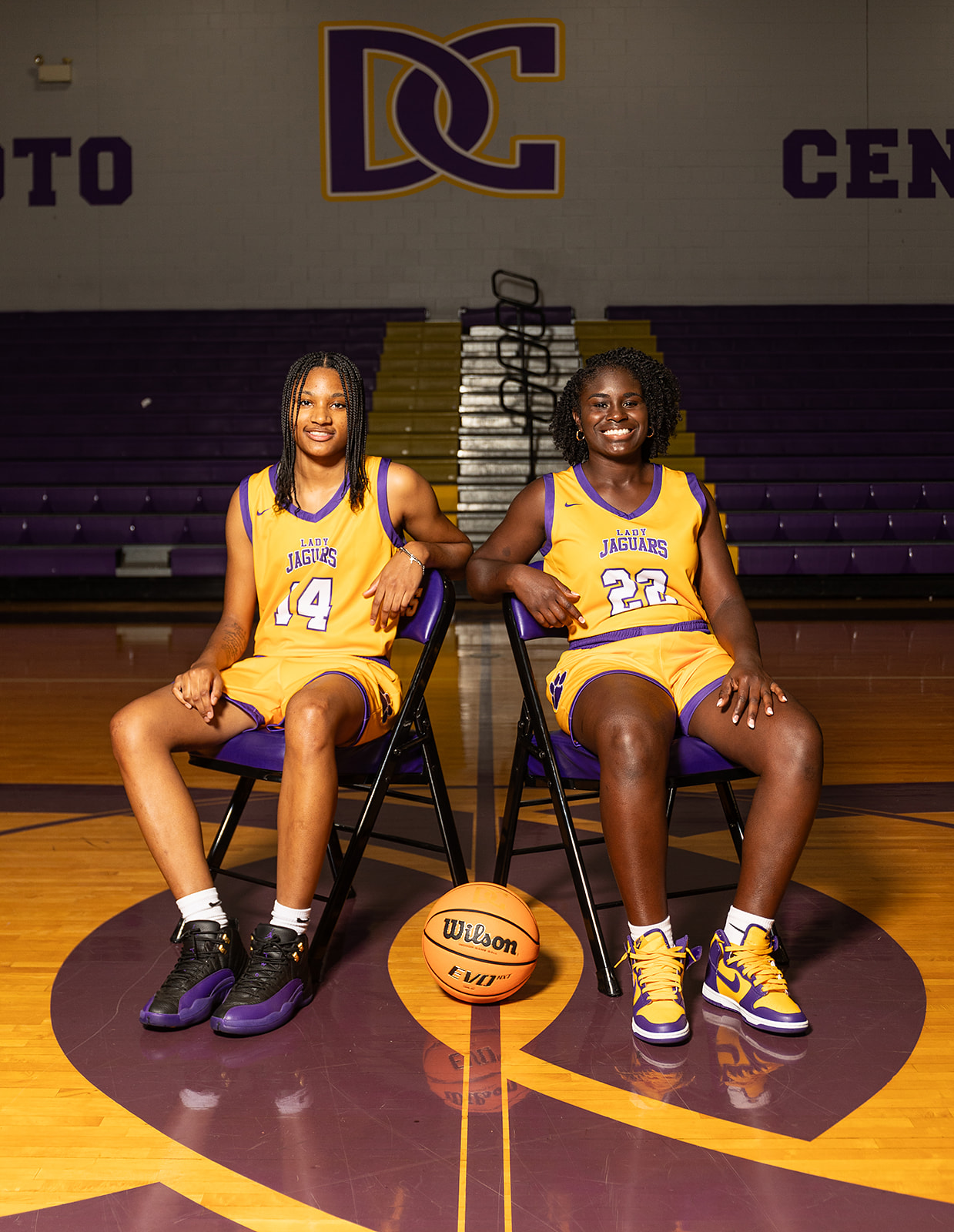 Jamaiya Hasley and Reagan Dale seated in chairs on the basketball court